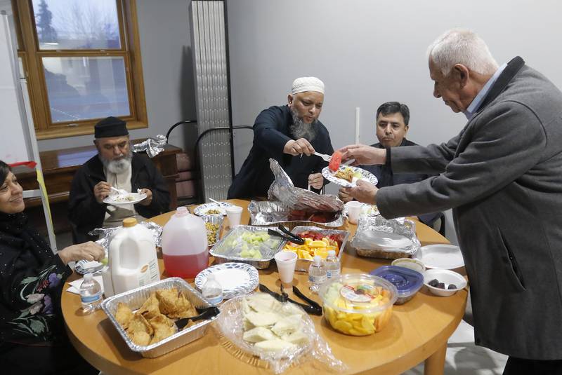 American Muslim Community Organization mosque members break the Ramadan fast Tuesday, March 29, 2023, at the organization's mosque in Lake in the Hills.