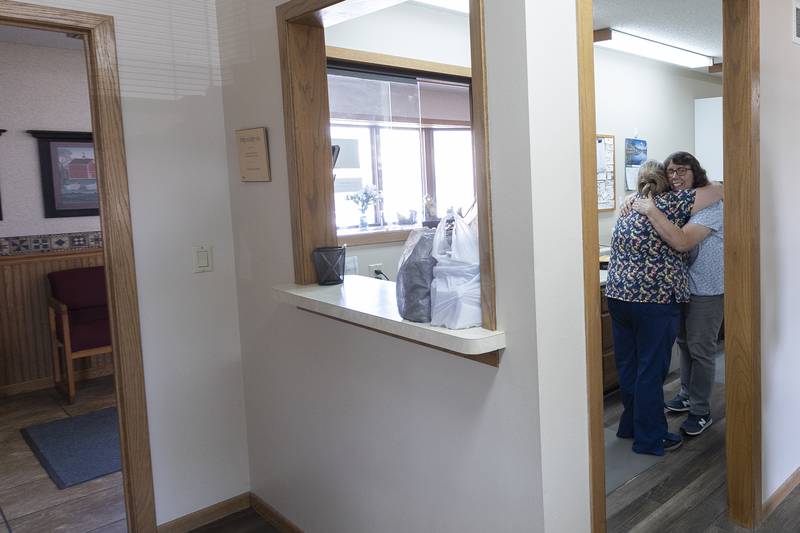 Becky Bartlett (right) gets a hug from Jennifer Payne Thursday, Sept. 26, 2024, at the Brokaw/German dental office in Dixon. The office is closing as the two dentists have decided to retire. The practice has been open since 1901 and was run by eight different doctors.
