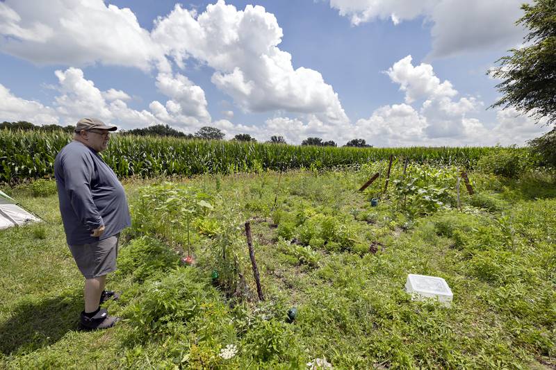 Newberry talks Tuesday, July 15, 2025, about a garden guests have planted and tend to at the PADS property.