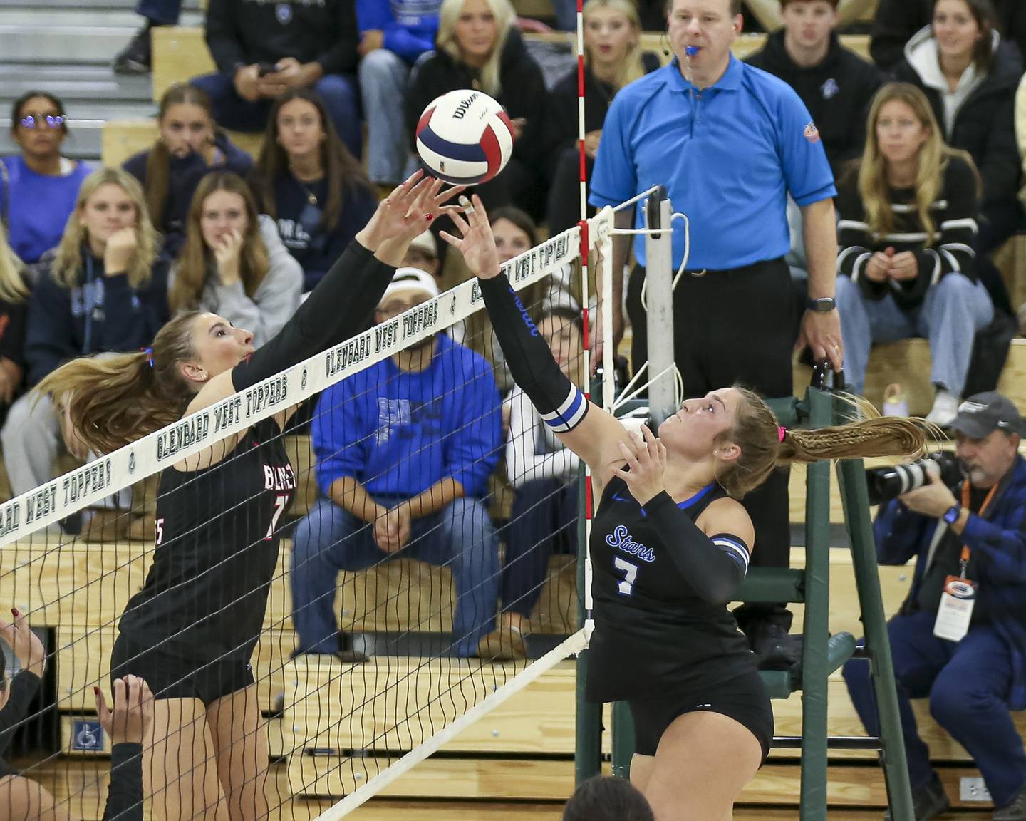 Benet's Sophia Chinetti (7) is met at the net by St Charles North's Mia McCall (7) during Class 4A Glenbard West Sectional final volleyball match between St Charles North at Benet. Nov 6, 2025 in Glen Ellyn.