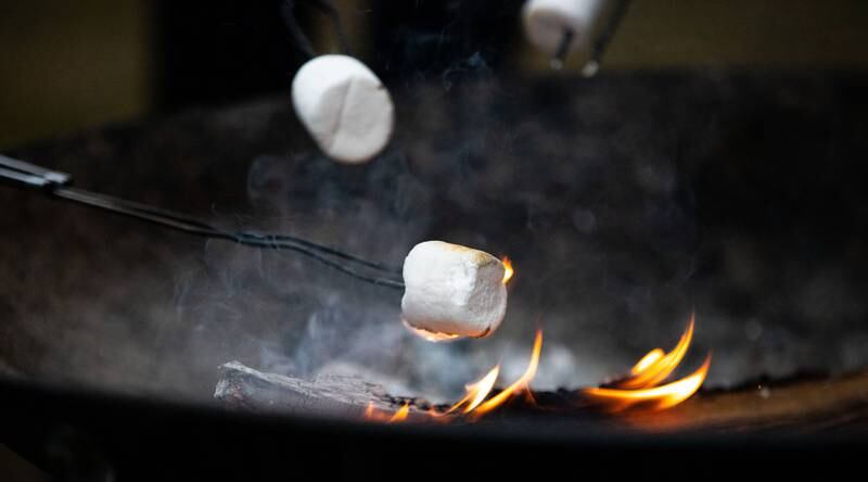 Merry & Bright Victorian Christmas attendees roasted Marshmallows outside the Downers Grove Museum on Saturday, Dec. 14, 2024.