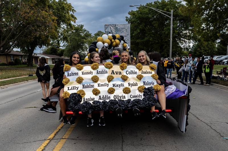 Members of Joliet West’s Dancing Tigers ride along Glenwood Ave. in Joliet during the Joliet West homecoming parade on Oct. 10, 2025.
