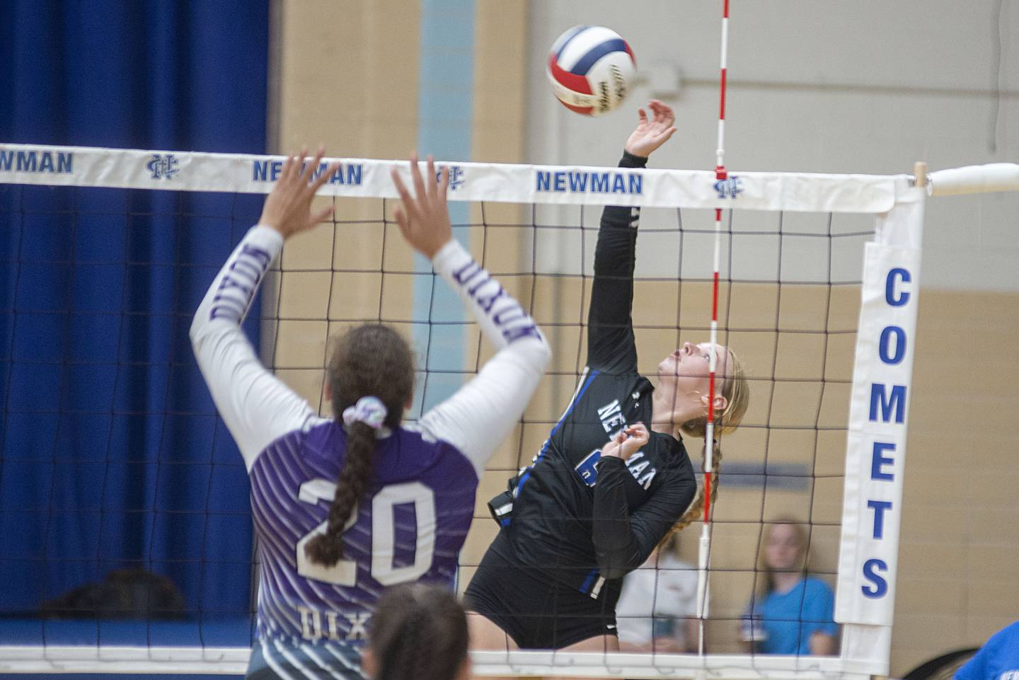 Newman’s Jess Johns spikes the ball against Dixon Monday, Aug. 29, 2022.