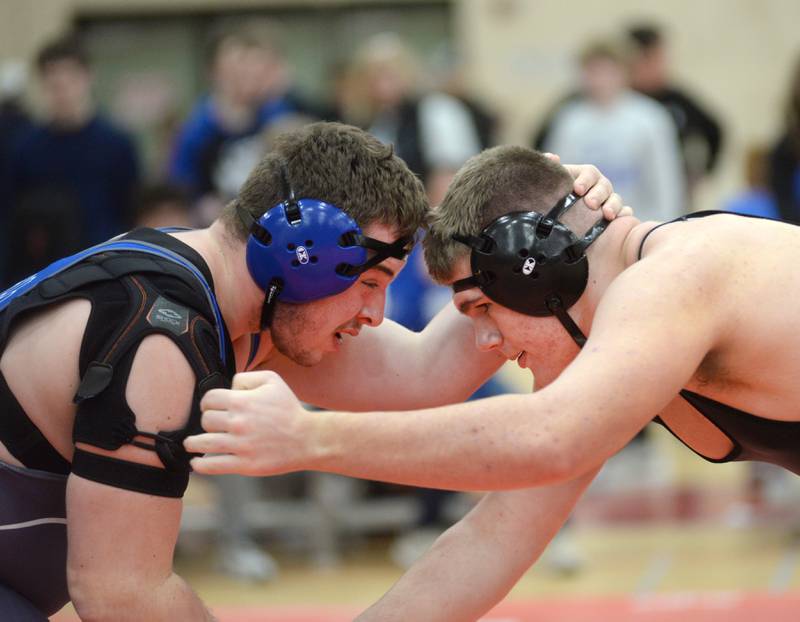 Erie-Prophetstown’s Caleb Rymer (right) and Princeton’s Cade Odell lock in at the start of their 285-pound match at the 1A Oregon Sectional on Friday, Feb. 14, 2025.