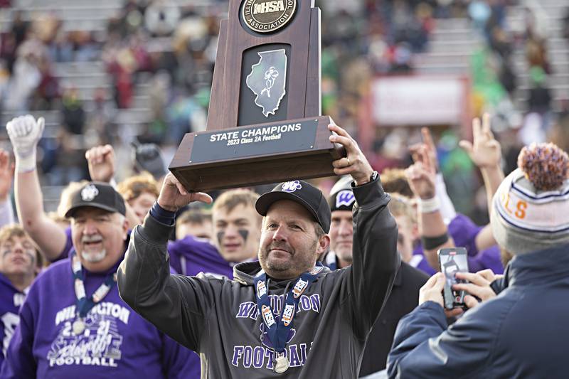 The Wilmington Wildcats and coach Jeff Reents celebrate their 28-3 win over Athens Friday, Nov. 24, 2023 in the 2A state football championship game at Hancock Stadium in Normal.