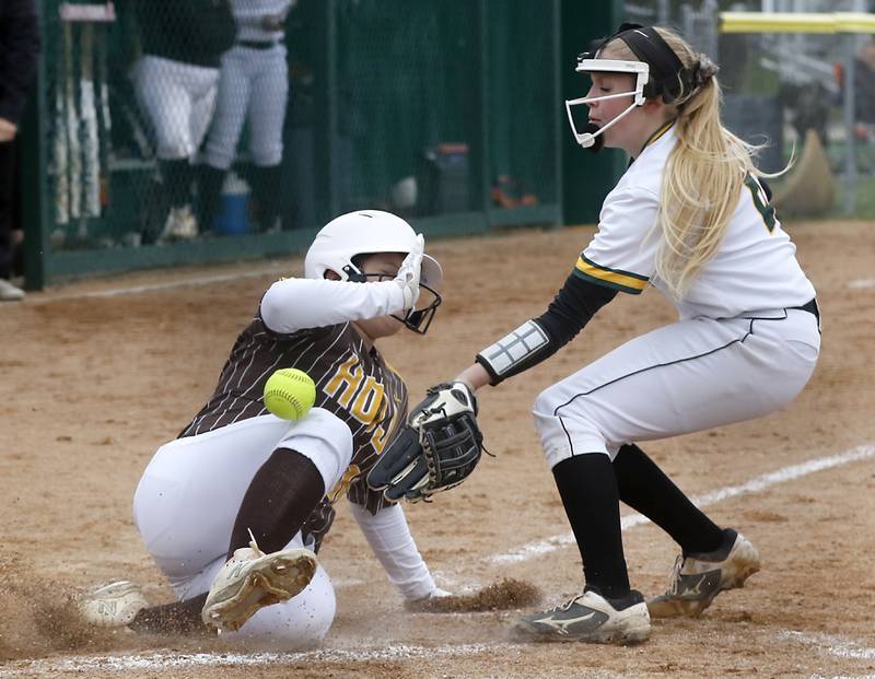 Jacobs’s Elizabeth Smith slides into home plate as Crystal Lake South pitch Kennedy Grippo tries to field the throw during a Fox Valley Conference softball game Monday, April 25, 2022, between Crystal Lake South  and Jacobs at Crystal Lake South High School.