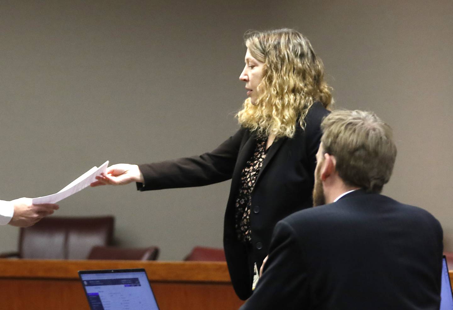 State's attorney Sharyl Eisenstein hands a piece of paper to the court security officer to hand to Judge Michael Coppedge on Monday, Nov. 14, 2022, during the trial of Robert J. Gould, 56. Gould, who was on McHenry County’s most wanted list when arrested in 2017, is accused of repeatedly sexually abusing two children throughout their childhoods beginning in 2001.