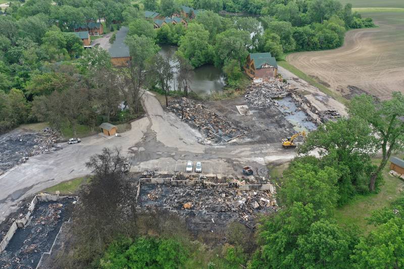 The foundations of three sets of cabins, dead trees, and burnt vehicles are all that remains after a major fire swept through the Grand Bear Resort and set fire to 28 cabins on Tuesday, May 31, 2022 in Utica.