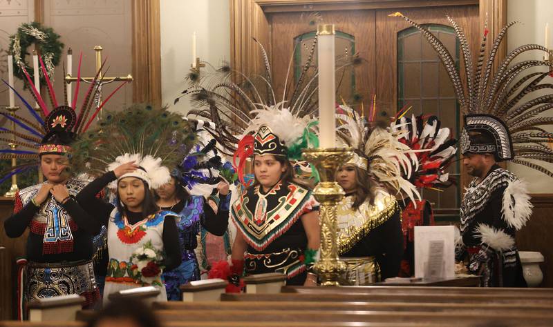 Dancers begin to walk into St. Patrick's Catholic Church to perform during the Lady of Guadalupe vigil Chichimeca dance on Thursday, Dec. 12, 2025 in La Salle. The Chichimeca dance is a vibrant, Indigenous-rooted devotional tradition where dancers (Danzantes) perform to honor the Virgin Mary's appearance to Juan Diego in 1531, symbolizing faith, hope, and cultural fusion, often involving elaborate costumes, feathers, and drumming, leading up to the main Feast Day on December 12th, with celebrations happening globally in parishes.