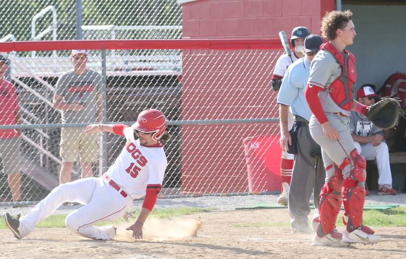 Streator's Kamden Emm scores a run as Ottawa catcher Packston Miller watches the play unfold on Tuesday, May 16, 2023 at Streator High School.