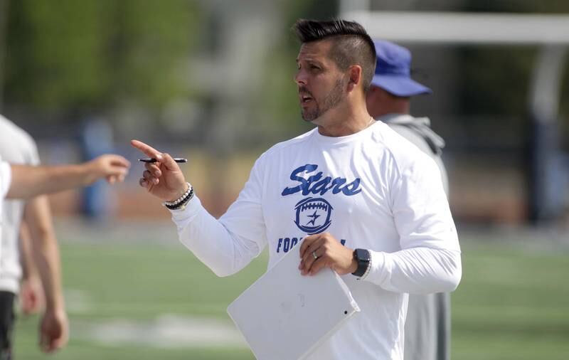St. Charles North Head Coach Rob Pomazak talks to his team during a 7-on-7 football game against Yorkville at St. Charles North on Thursday, June 22, 2023.