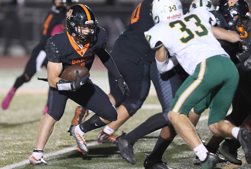 DeKalb's Talen Tate looks to get past Waubonsie Valley's Garen Bishop during their game Thursday, Oct. 20, 2022, at DeKalb High School.