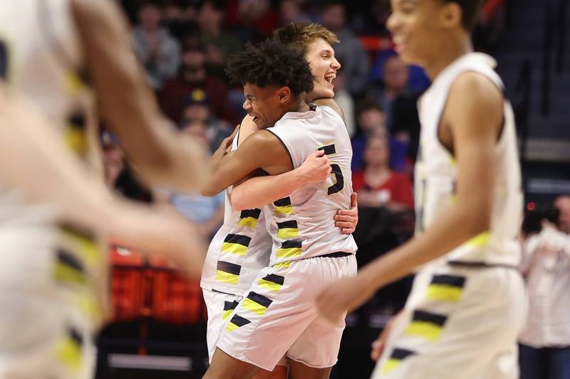 Yorkville Christian’s Jaden Schutt (2) and Tyler Burrows (5) embrace after their 54-41 win over Liberty in the Class 1A championship game at State Farm Center in Champaign. Friday, Mar. 11, 2022, in Champaign.