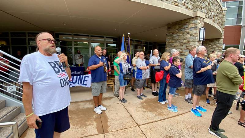 Veterans and their families salute as the national anthem is sung to kick off the inaugural Be the One Walk to spread awareness about veteran suicide rates. The 2.2-mile trek organized by DeKalb County area veterans groups to mark the roughly 22 veterans who die by suicide yearly set out from Northwestern Medicine Health and Wellness Center, 626 Bethany Road, DeKalb, and drew a large crowd Sunday, Sept. 22, 2024.