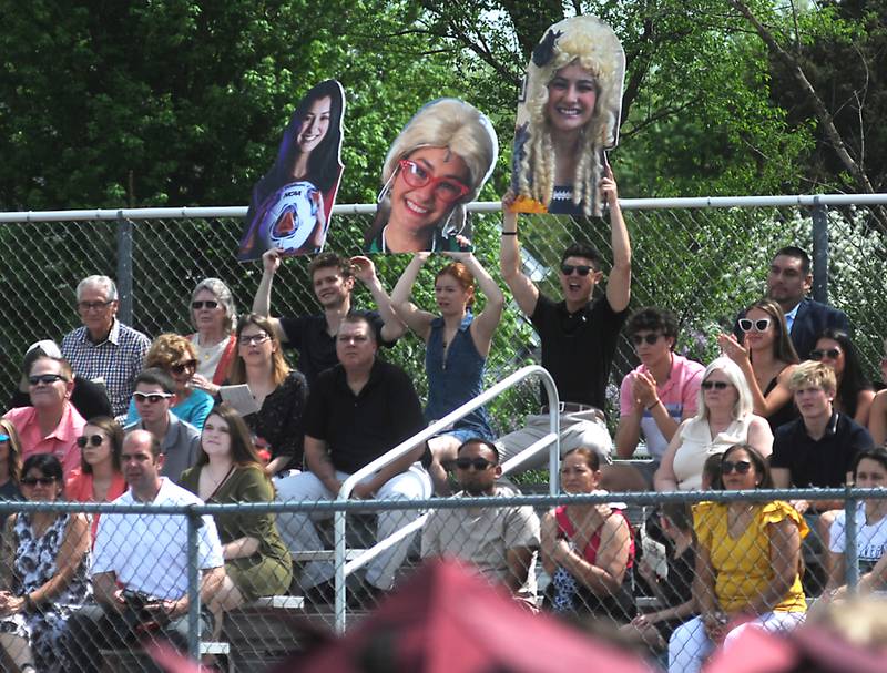 Big heads are held up by the siblings of Camille Keaty, not pictured, Tommy, from left to right, Chloe and Billy Keaty, on Saturday, May 14, 2022, during the graduation ceremony at Prairie Ridge High School.