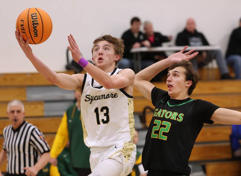 Sycamore's Xander Lewis gets to the basket ahead of Crystal Lake South's Tony Santarelli during their sectional semifinal game Tuesday, March 4, 2025, at Rochelle High School.