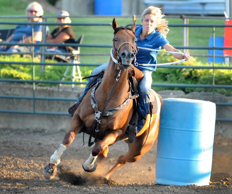 Cortney Pyse of Harmon rounds the second obstacle in the barrel racing competition during the Kendall County Fair in Yorkville on Thursday, Aug. 3, 2023.