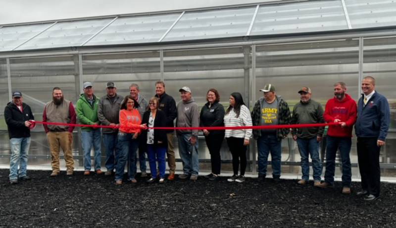 Volunteers, staff members and students celebrate at a ribboncutting Thursday for Morrison High School's new greenhouse.