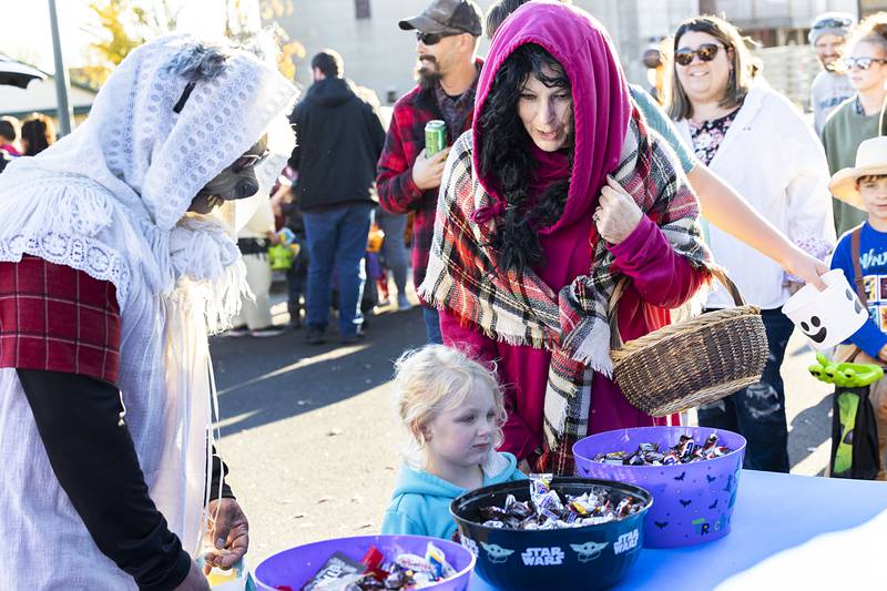 Dressed as Grandma Wolf and Little Red Riding Hood Steve and Amy Lopez leads their granddaughter Bella Styles, 3, through Sterling Police’s trunk or treat event.