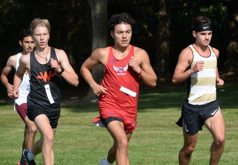 Oregon's Daniel Gonzalez (center) runs with Winnebago's Joseph Erb (left) and Rockford Christian's Lukas White in the Oregon Cross Country Open on Saturday, Sept. 6, 2025 at Oregon Park West.