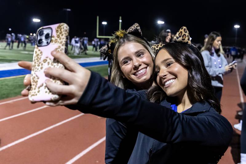 Members of Lincoln-Way East’s cheer team take a selfie prior to a varsity football round one playoff game against Stevenson at Lincoln-Way East on Oct. 31, 2025.