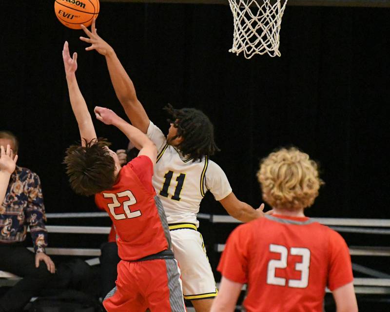 Yorkville Christian's Kayden Maxwell (11) blocks the hot of Aurora Christian's Jacob Baumann (22) during the game on Friday Feb. 28, 2025, held at Indian Creek High School.