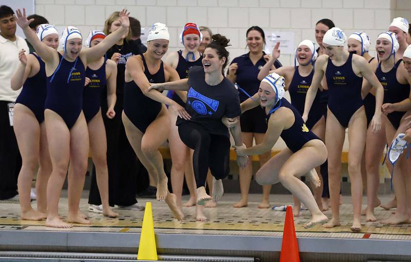 Lyons Township's Head Coach Megan Jacobs is thrown in the pool after her team took second place against Stevenson during the IHSA State Finals of the Girls Water Polo Saturday, May 24, 2025 at Stevenson High School in Lincolnshire.