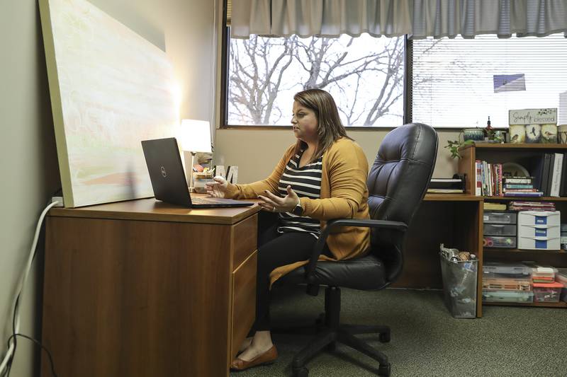 Therapist Meaghan Dugan of Trinity Counseling prepares to speak with a patient on Thursday, Jan. 14, 2021, at Trinity Services Inc. in Joliet, Ill. Due to quarantines and lock downs, telehealth and online therapy has become a vital service for individuals during their time of need.