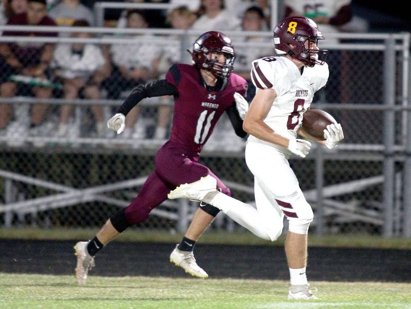 Marengo’s Alten Bergbreiter, left, pursues Richmond-Burton’s Jack Martens as Martens runs in a first-half touchdown in varsity football at Rod Poppe Field in Marengo Thursday night.