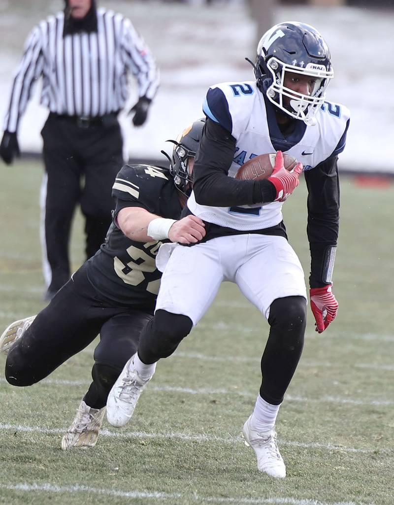Nazareth's Justin Taylor tries to pull away from Sycamore's Joey Puleo Saturday, Nov. 18, 2022, during their state semifinal game at Sycamore High School.