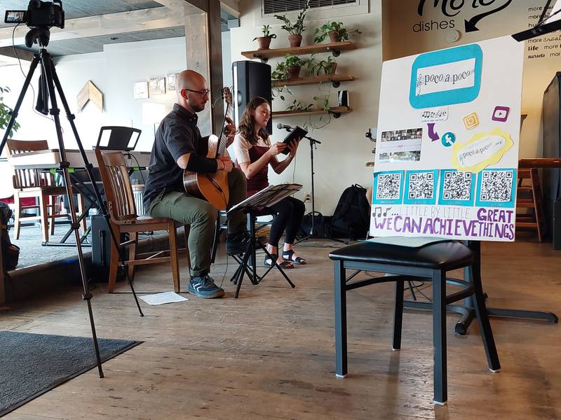 Mary Bond sings "Asturiana" by Manuel de Falla while Ascher Taylo-Schroeder plays the guitar Wednesday, June 14, 2023, during Poco a Poco's Coffeehouse Concert at More on Main in Streator.