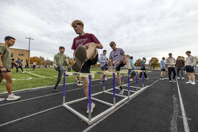 The Dixon boys cross country team warms up on the track of DHS Thursday, Nov. 6, 2025. The team is gearing up for this weekend’s state tournament.