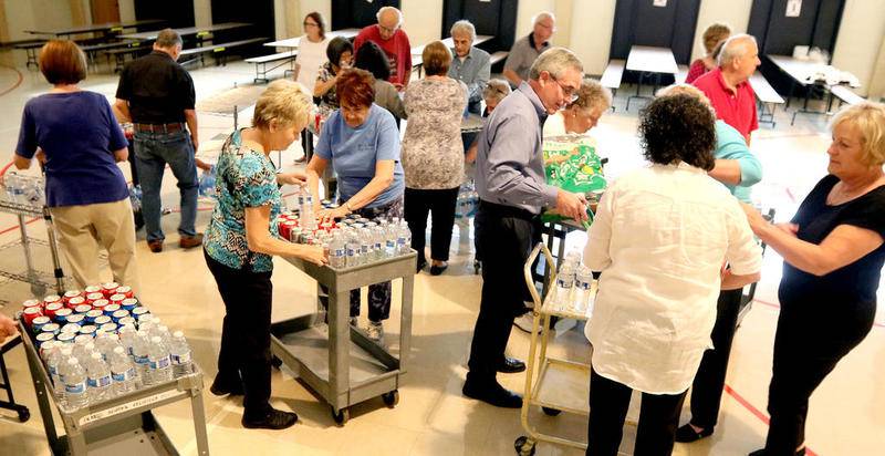 Water and soda are organized ahead of a Community Friends Banquet at St. Peter Catholic Church in Geneva on July 28.
