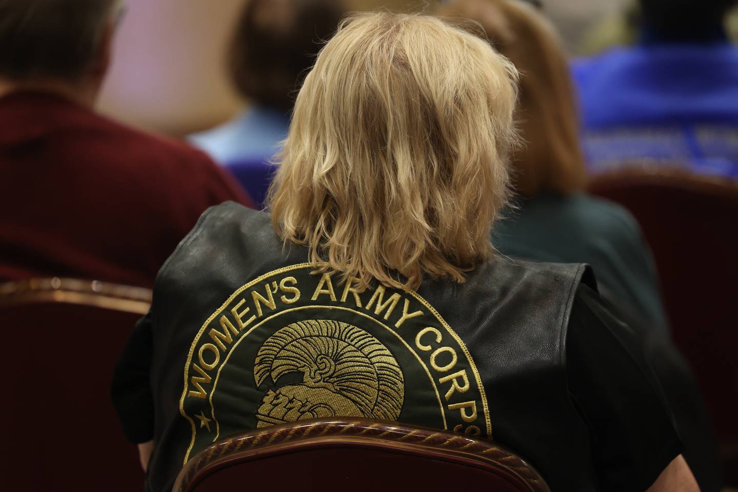 Denise Carson, an Army veteran and an ambassador for Honor and Remember, wears her Women’s Army Corp vest while listening to a guess speaker at the Salute to Armed Forces event at the Double Tree in Alsip on Wednesday, Oct. 11, 2023.