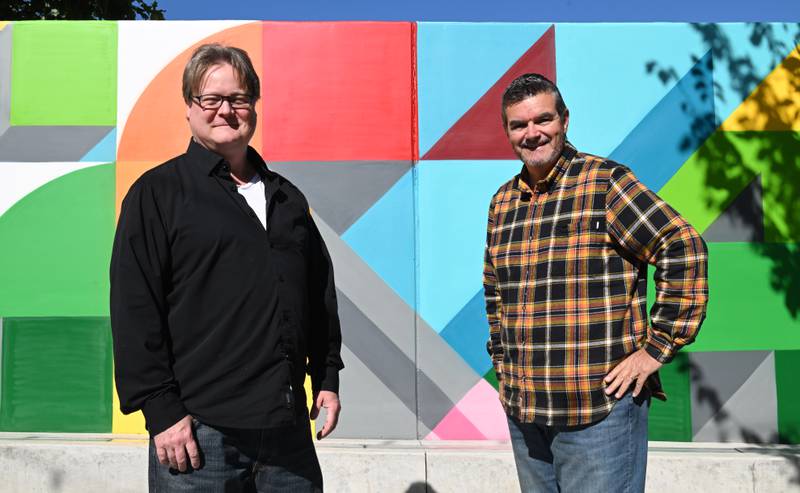 Lewis Achenbach, left, and Randy King stand in front of a vibrant new mural on Wednesday, Oct. 16, 2024 in Wheaton.