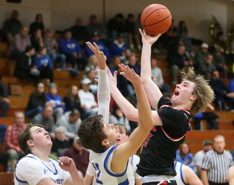 Hall's Wyatt West eyes the hoop as Princeton's Tyson Phillips and Wyatt Koning on Friday, Jan. 26, 2024 at Princeton High School.