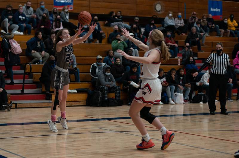 Oswego East's Katie Jorgensen (22) shoots a three pointer against West Aurora during a basketball game at West Aurora High School on Wednesday, Jan 26, 2022.