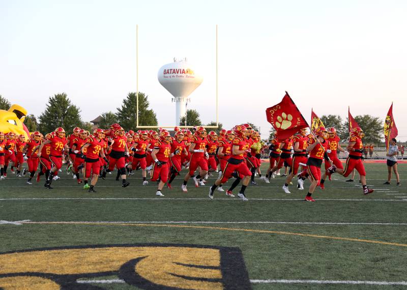 The Batavia High School varsity team takes the field before their season-opener against Phillips in Batavia on Friday, Aug. 25, 2023.