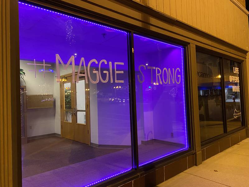 A sign reads "#MaggieStrong" outside the Sycamore City Center, 308 W. State St. downtown in honor of Sycamore sixth grader Maggie Green, 11, who died Wednesday, Nov. 29, 2023, from cancer. Purple lights have been displayed across town for weeks to support Maggie and her family. Purple was Maggie's favorite color.