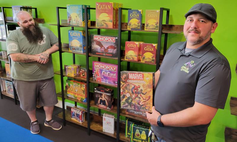 Co-owners Kevin Bennett (left) and Andy Bryan display just some of the games available at their new store, Goblin Gaming, located at 712 La Salle St., in Ottawa. The grand opening is slated for Thursday.