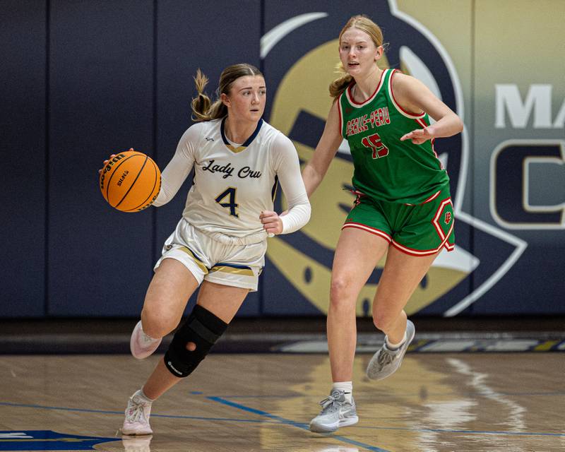 Hunter Hopkins (4) of Marquette dribbles ball down court as Margaret Boudreau (15) of LaSalle-Peru trails on Saturday, January 3, 2026 at Marquette Academy in Ottawa.