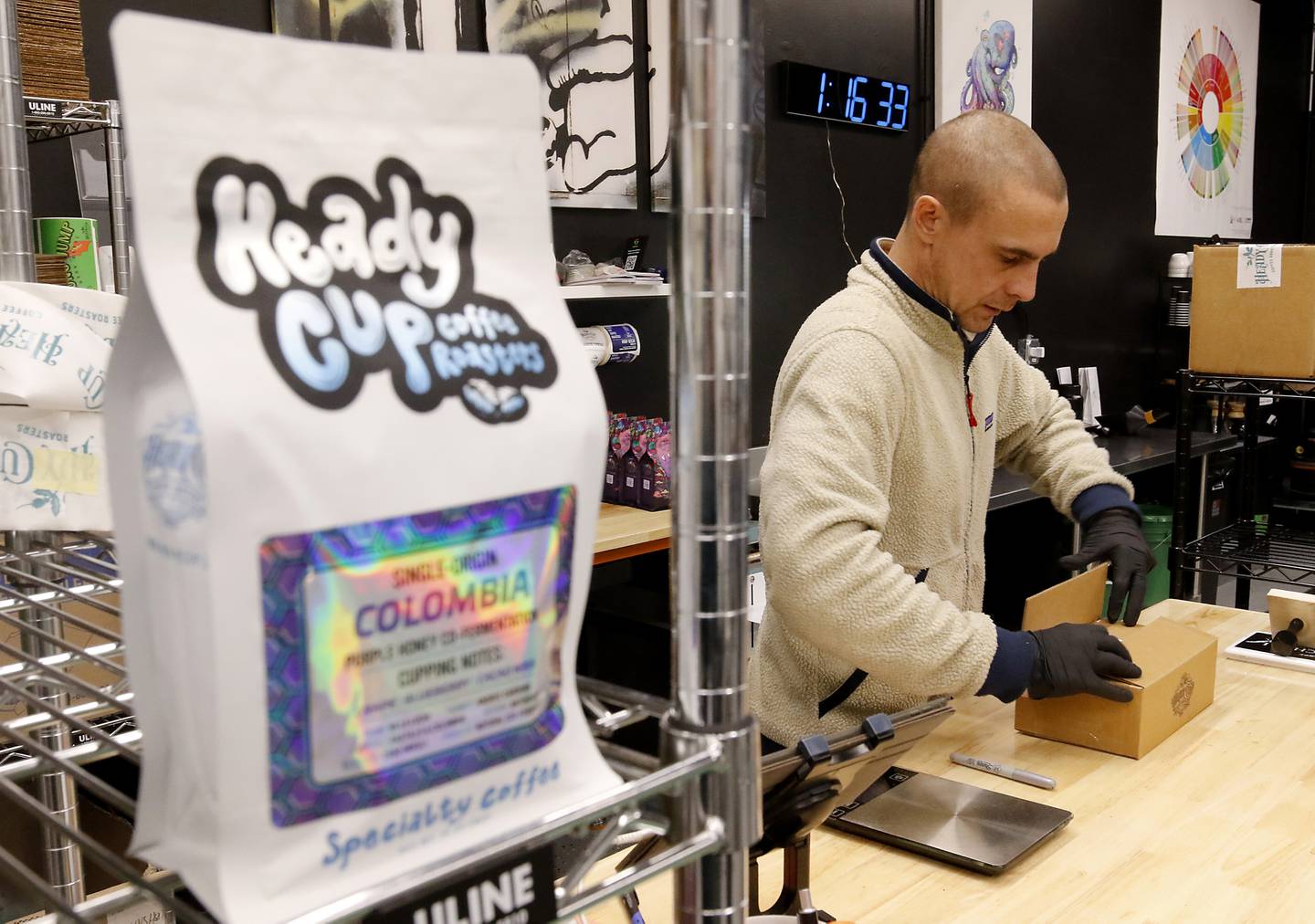Kevin Foglesong, a co-owner of Heady Cup Coffee Roasters, packs an order on Friday, Feb. 14, 2025, at the business in McHenry.