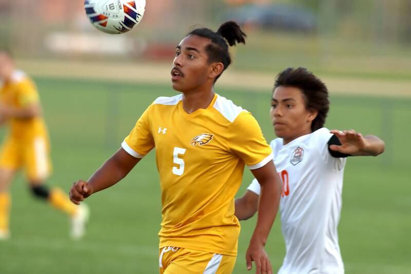 Crystal Lake Central’s  Danny Vega, right, races Jacobs’ Alex Trujillo for the ball in varsity boys soccer on Thursday at Algonquin.