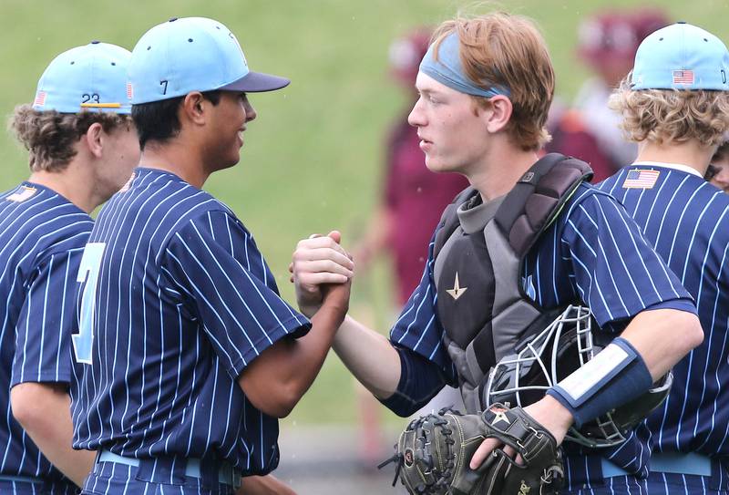 Nazareth pitcher Sebastian Gutierrez and catcher Sam Wampler shake hands after their 16-3 win over Crystal Lake South Friday, June 10, 2022, in the IHSA Class 3A state semifinal game at Duly Health and Care Field in Joliet.