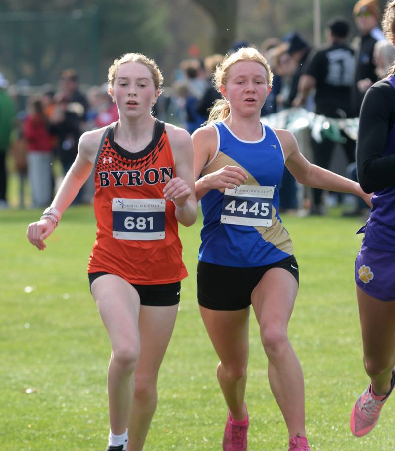 Byron's Ashley Potter (left) races Rockford Christian's Riley Fritz to the finish line at the 1A Rock Island Cross Country Sectional on Saturday, Nov. 2, 2024 at Saukie Golf Course in Rock Island.