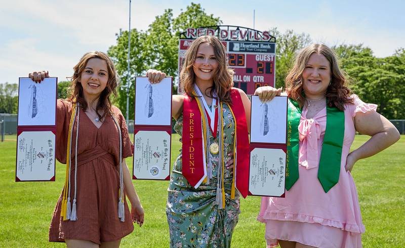 Hall graduates KatrinaMoats, Izzie Cacciatori, and Kambria Simmons hold their diplomas during the graduation ceremony on Sunday May 21, 2023 at Hall Township High School.
