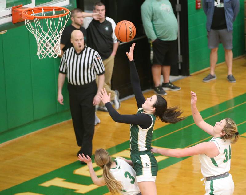 St. Bede's Ali Bosnich runs between Seneca's Evelyn O'Connor and Tessa Krull to score on a layup on Monday, Jan. 29, 2024 at Seneca High School.