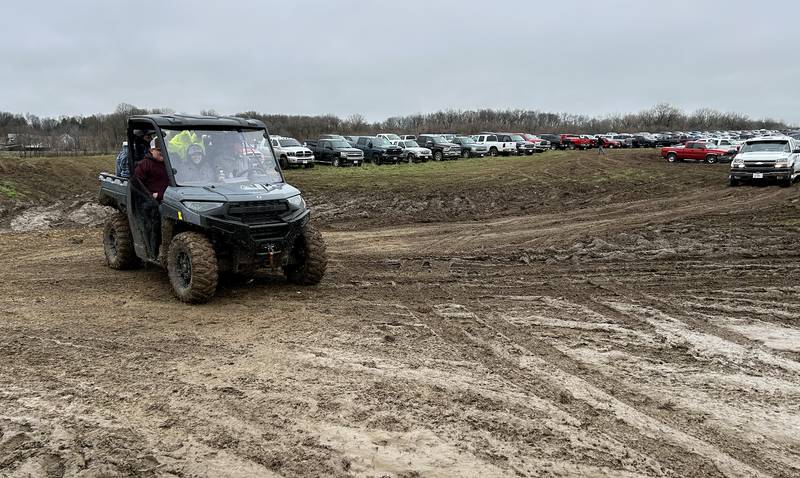 Some attendees at the Spring Hazelhurst Consignment Sale used all-terrain vehicles to navigate through the mud on Saturday, April 4, 2026. The annual auction is held on a farm field between Polo and Milledgeville.