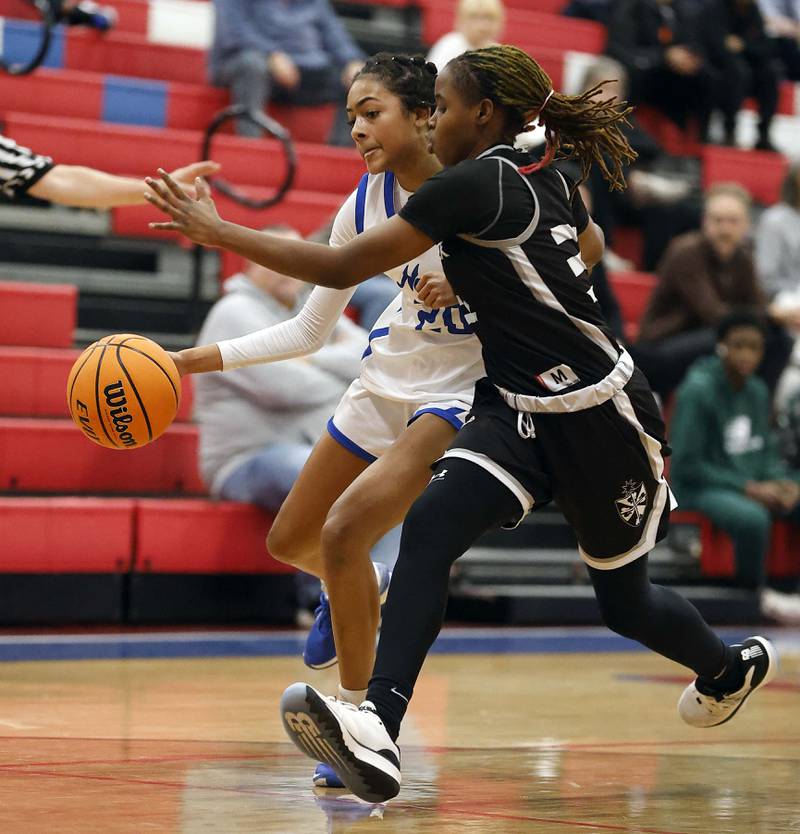 St. Charles North's Sydney Johnson (20) moves the ball up court as Fenwick's Darryelle Smith (31) pressures her during the Dundee-Crown High School 41st Annual Komaromy Classic Friday, Dec. 27, 2024 in Carpentersville.