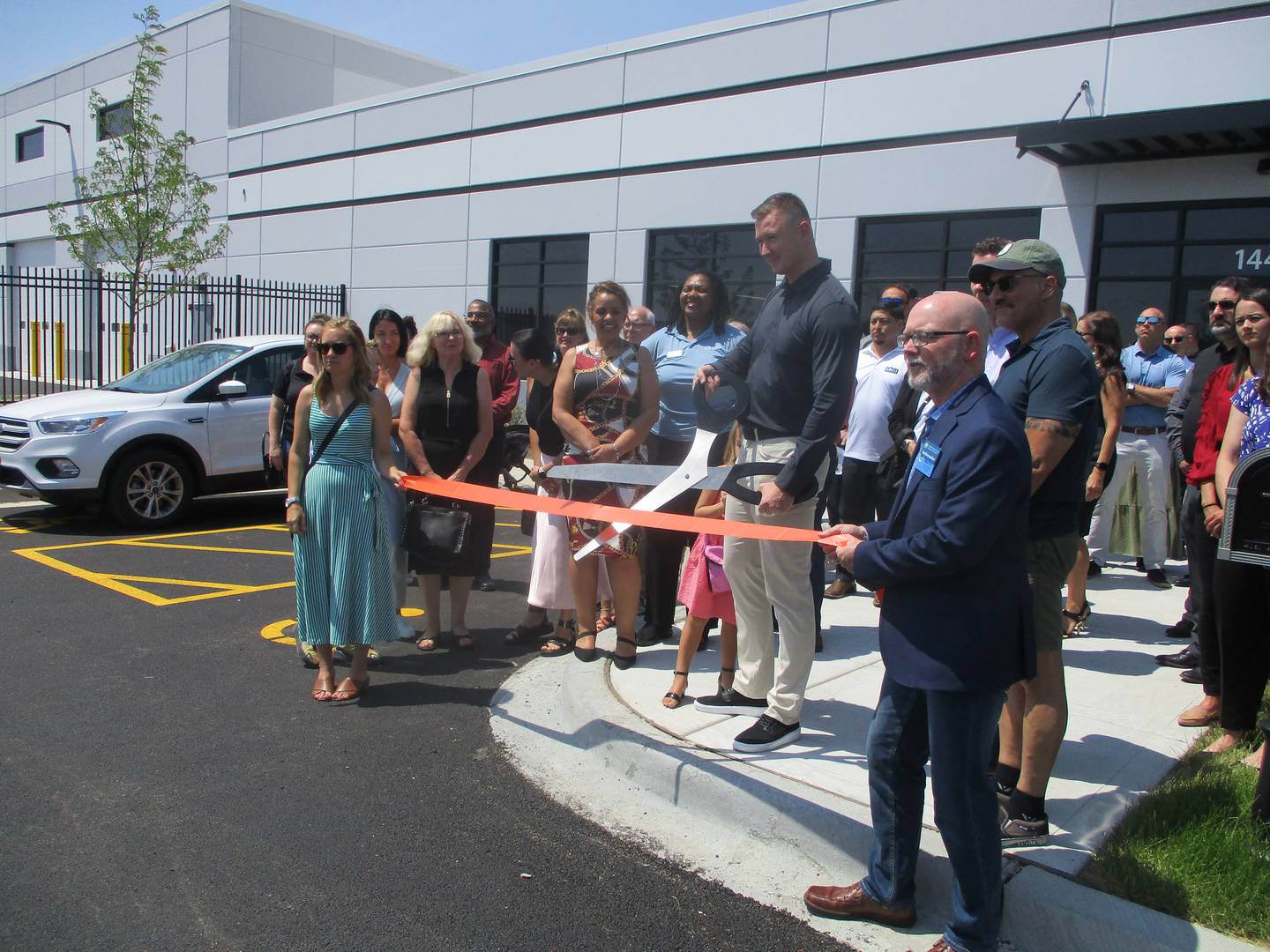 MNS1 Express Inc. President Mike Narkys prepares to cut a ribbon at a ceremony outside the company's new facility in Plainfield on Thursday, June 1, 2023.